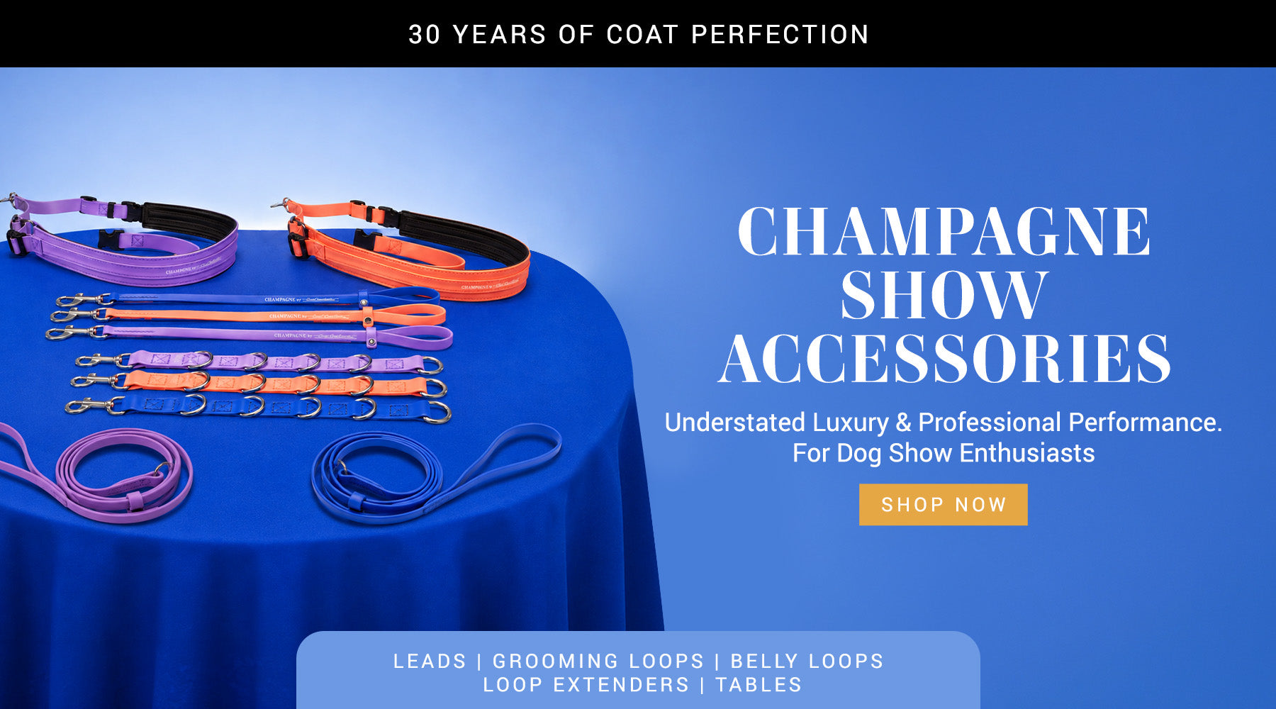 Dog show accessories on a blue tablecloth with promotional text and branding.